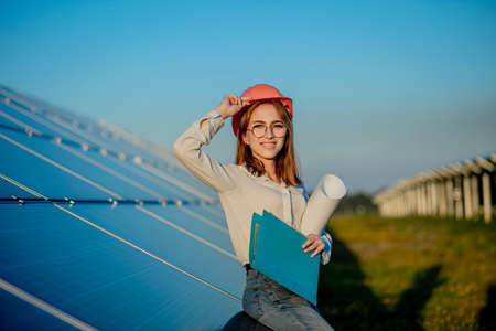 Businesswomen working on checking equipment at solar power plant with tablet checklist, woman working on outdoor at solar power plant.の写真素材