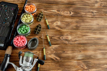 Accessories for carp fishing and fishing baits on wooden planks with copy space.の写真素材