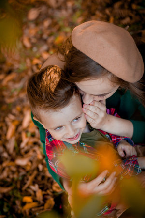 Happy young mother playing and having fun with her little baby son on sunshine warm autumn day in...