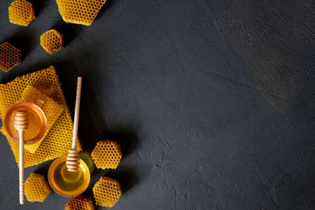 Healthy Thick honey dipping from the wooden honey spoon, bee products by organic natural ingredients concept.の写真素材