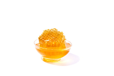 Bowl of honey isolated on white backgroundas package design element.
