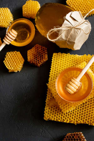 Jar of honey with honeycomb on black table, top view. space for text.の写真素材