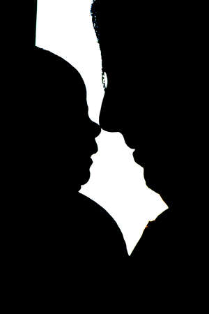 Silhouette of a mother holding her newborn babyの写真素材