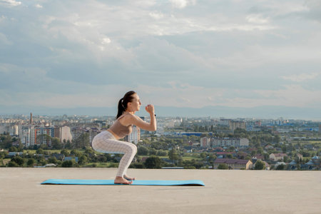 Side view of muscular young woman with long ponytail in sunny morning. Gorgeous girl practicing...
