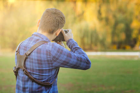 Professional photographer in action with two cameras on a shoulder straps.の写真素材
