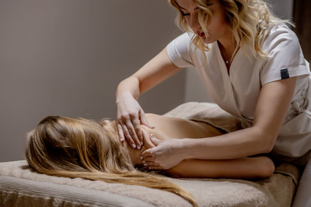 Masseur doing massage on man body in the spa salon. Beauty treatment conceptの写真素材