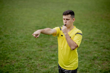 Referee indicates a violation of the rules. Concept of sport, rules violation, controversial issues, obstacles overcomingの写真素材