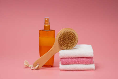 Flat lay composition with spa cosmetics and towel on pink background.の写真素材