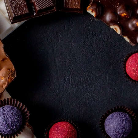 Rustic banner with luxury handmade chocolates and three types of chocolate with vignette and copy spaceの写真素材