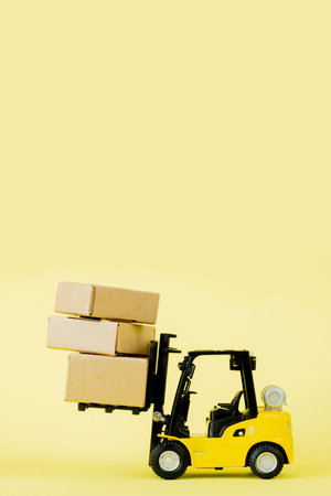 Mini forklift truck load cardboard boxes. Logistics and transportation management ideas and Industry business commercial conceptの写真素材