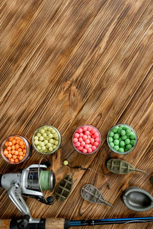Accessories for carp fishing and fishing baits on wooden planks with copy space.の写真素材