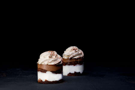 Petit fours or mini chocolate crepe cakes with chocolate on black background.の写真素材
