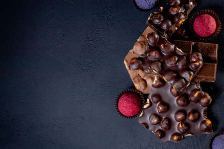 Chocolates background. Chocolate. Assortment of fine chocolates in white, dark, and milk chocolate. Praline Chocolate sweets.の写真素材