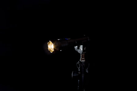 Flashlight and beam of light on a black background.の写真素材