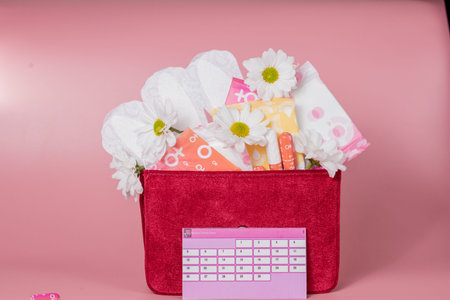 Menstruation calendar with cotton tampons, sanitary pads, white flower. Woman critical days, woman...