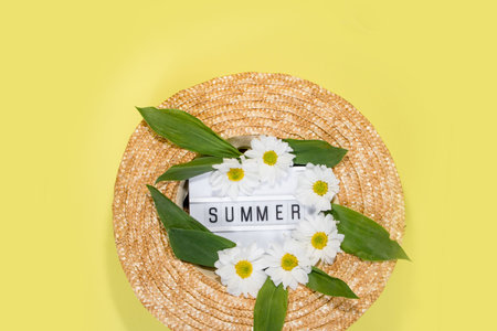 Womens summer straw hat on yellow background top view flat lay copy space. Summer travel vacation...