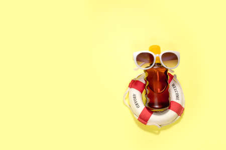 Cosmetics SPF for face and body on yellow background. Top view, flat layの写真素材