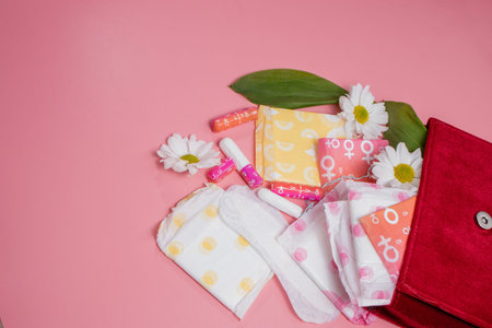 Menstrual tampons and pads in cosmetic bag. Menstruation cycle. Hygiene and protection.