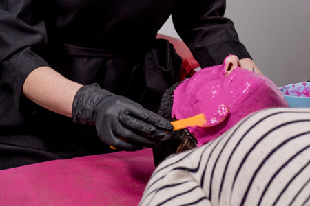 Beautiful young woman at the reception at the beautician, alginate mask, the process of applying to...
