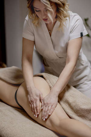 Close up of anti cellulite massage for young woman in wellness center. Problems of women body. Perfect skin fat burning beauty conceptの写真素材