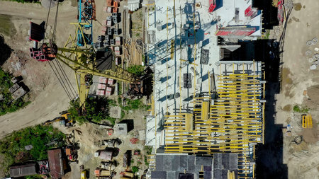 Aerial view of high residential apartment building under construction. Real estate development.