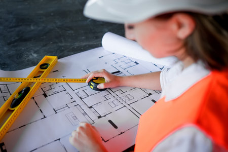 Architect working over plan. Closeup Desk With blueprints drawing