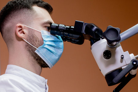 A young scientist conducting research with a microscope. Working with a microscopeの写真素材