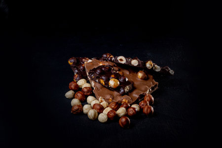 Top view in section on a bar of dark chocolate with hazelnuts.の写真素材