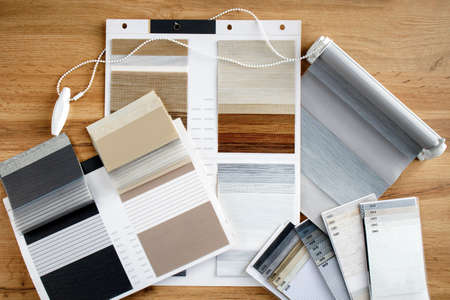 Samples of fabrics of different textures and colors in the form of a catalog for the selection of fabrics for fabric blinds. Samples of blinds day and nightの写真素材