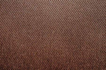 Brown background with dense textured fabric for sun blinds or mat, wallpaper, close up. Fabric background.の写真素材