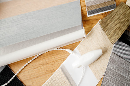 Samples of fabrics of different textures and colors in the form of a catalog for the selection of fabrics for fabric blinds. Samples of blinds day and nightの写真素材