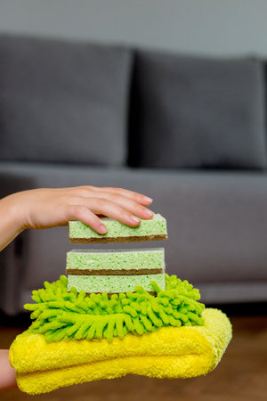 Colored rags and washcloths for manual cleaning on a woman's hand. House cleaning.の写真素材