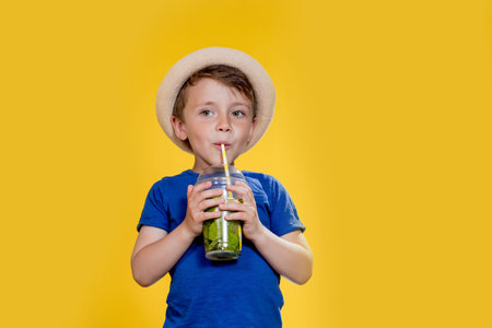 Summer refreshment. Cold beverage. Little boy with plastic cup of fresh lemonade.