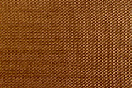 Brown background with dense textured fabric for sun blinds or mat, wallpaper, close up. Fabric background.の写真素材