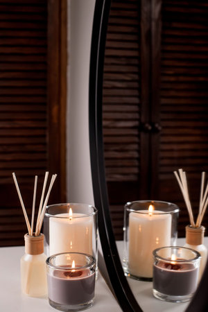 Aroma diffuser and scented candles that create coziness in the house. romantic atmosphere. Details...