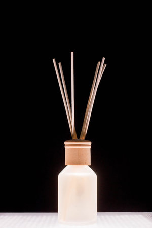 Fragrance for home. Aroma diffuser glass jar with aromatic liquid and bamboo sticks.
