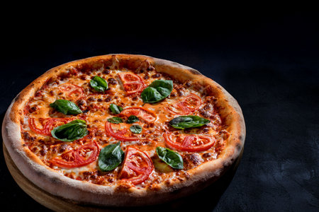 Delicious fragrant pizza with mozzarella, tomatoes and basil with tomato sauce - Margherita.の写真素材