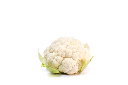 Whole head of fresh white raw cauliflower with leaves close-up on white background. isolated on white background.の写真素材