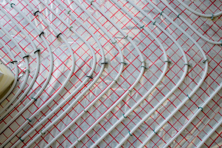 Close-up of Installed Pipes for Warm Floor ready for connection to a heat pump or boiler. Efficient Underfloor Heating System.の写真素材