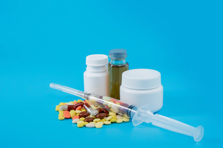 Pharmaceutical preparation, medicine in jars, pills in syringe for injection. treatment concept.の写真素材