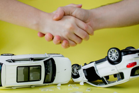 Customer shake hand with auto insurance agents examining car crash owner after agreeing to find a...