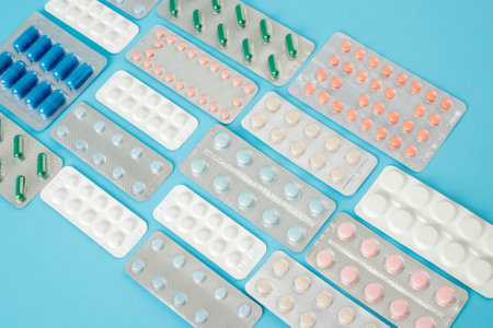 Colorful of tablets and capsules pill in blister packaging arranged with beautiful pattern with flare light. Pharmaceutical industry concept. Pharmacy drugstore.の写真素材