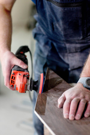 Professional tiler grinding tiles for installing floor. Construction, renovation, repair apartments