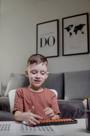 Little preschooler counting large numbers on his fingers using mental arithmetic, concept of the development of the two hemispheres of the child's brain.の写真素材