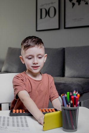 Little boy Counting with help an abacus. Mental arithmetic, brain development.