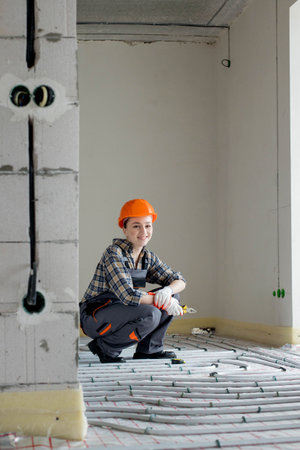 Portrait of woman worker which is installing underfloor heating system. Warm floor heating system.の写真素材