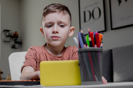 Boy is thinking about solving the problem. Mental arithmetic. Adding numbers.
