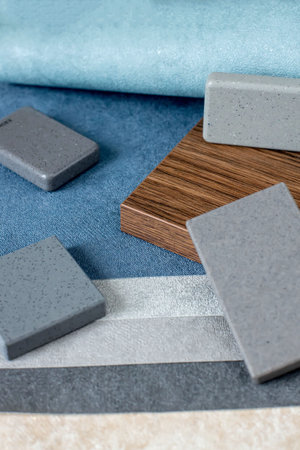Samples of materials for interior design. Fabric wallpaper, samples of artificial stone, wood.
