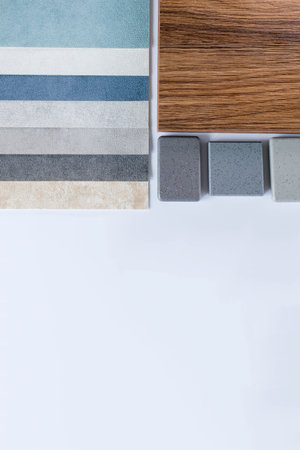 Samples of materials for interior design. Fabric wallpaper, samples of artificial stone, wood.