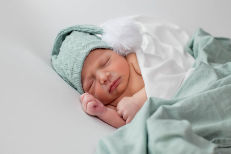 Close up of cute newborn baby sleeping on white background covered.Care,love,happiness conceptの写真素材
